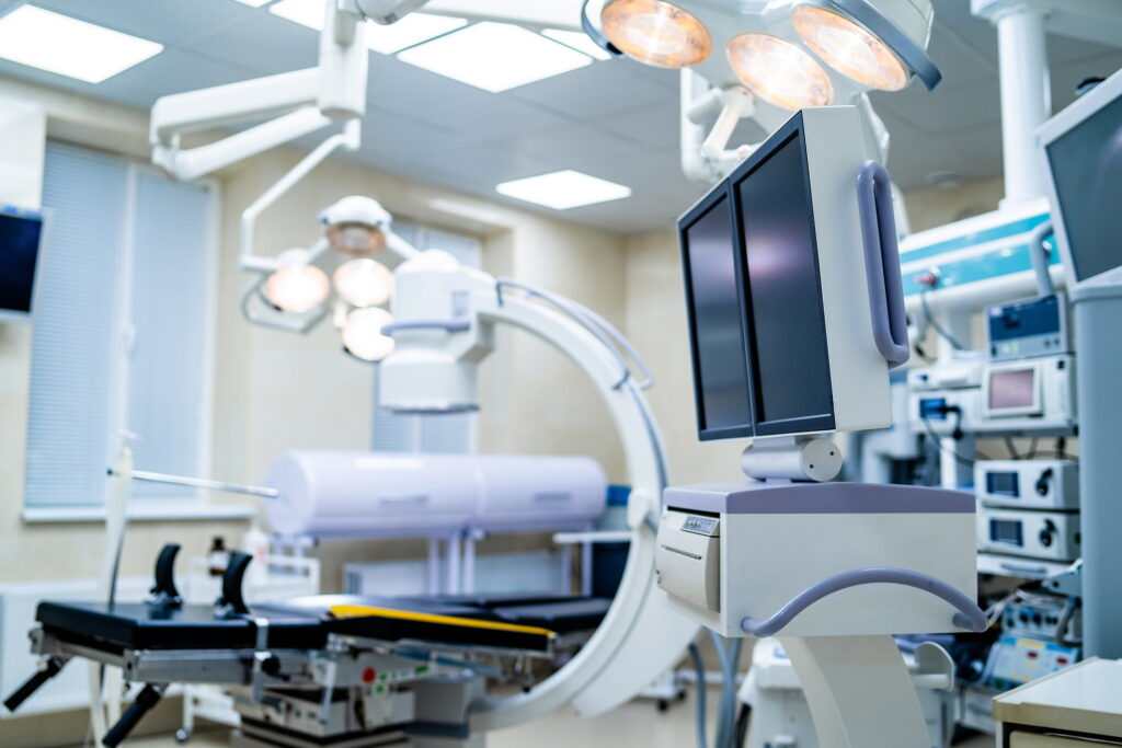 Clinic interior with operating surgery table, lamps and ultra modern devices, technology, hi-tech interior, medicine concept