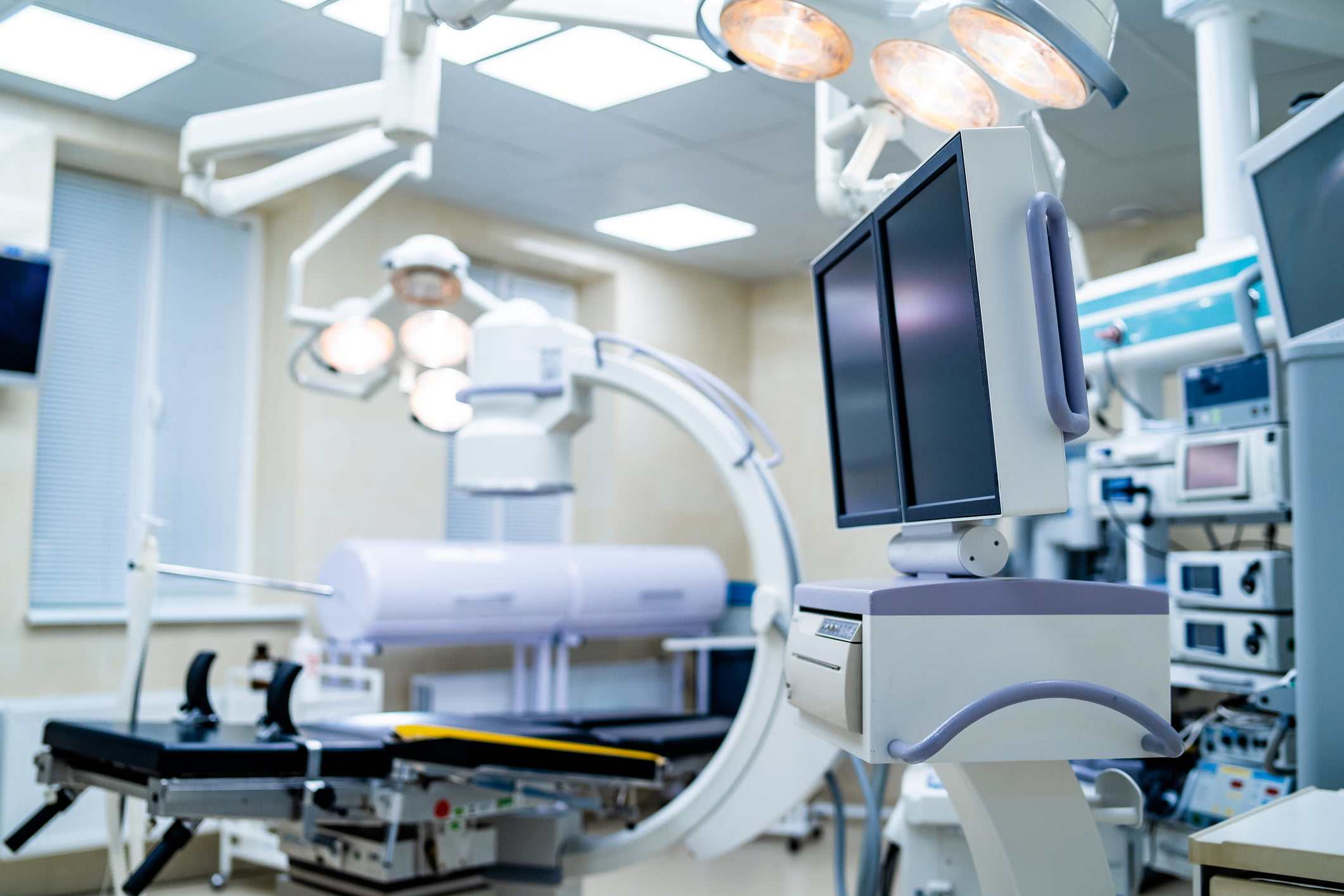 Clinic interior with operating surgery table, lamps and ultra modern devices, technology, hi-tech interior, medicine concept