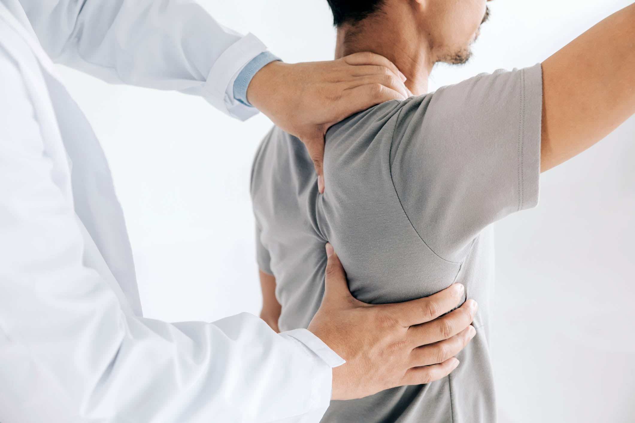 Physiotherapist doing healing treatment on man's back.Back pain patient, treatment, medical doctor, massage therapist.office syndrome