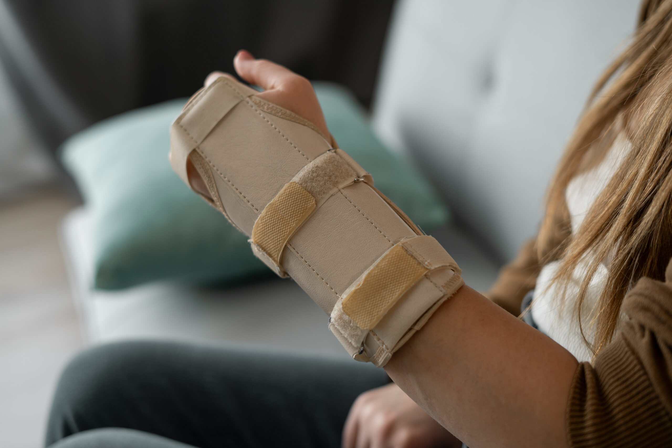 Hand injury. Broken wrist and arm with bandage or immobilizer. woman uses hand splints. Inflammation.